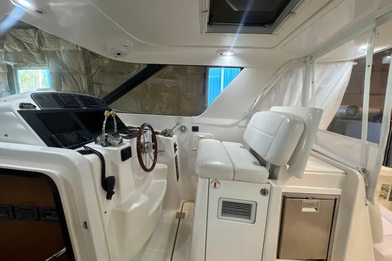 Slide: The Image of 2006 Tiara Yachts 3600 Sovran helm with white seating and modern controls. - 45