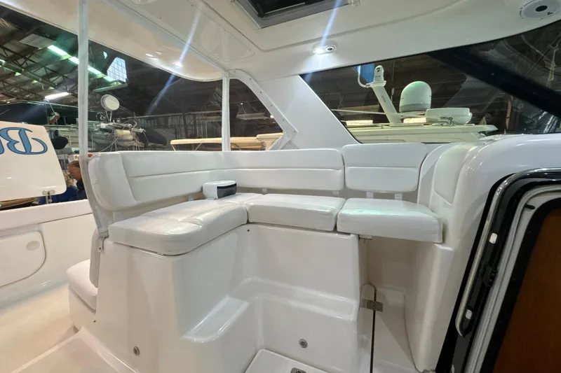 Slide: The Image of 2006 Tiara Yachts 3600 Sovran interior with white seating in a boat showroom. - 47