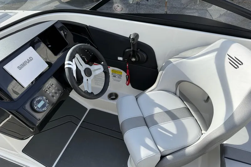 Slide: The Image of 2026 Bayliner V20 boat cockpit with steering wheel and control panel. - 11