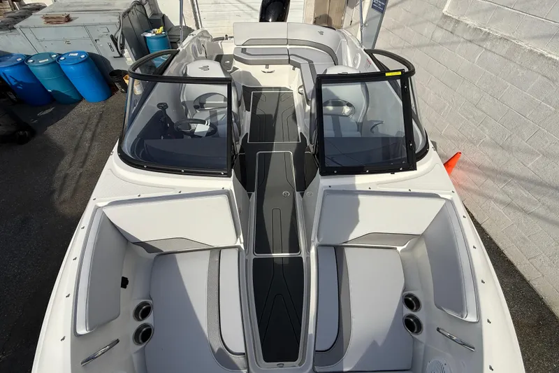 Slide: The Image of 2026 Bayliner V20 boat interior with open windshield, showcasing seating and storage areas. - 14