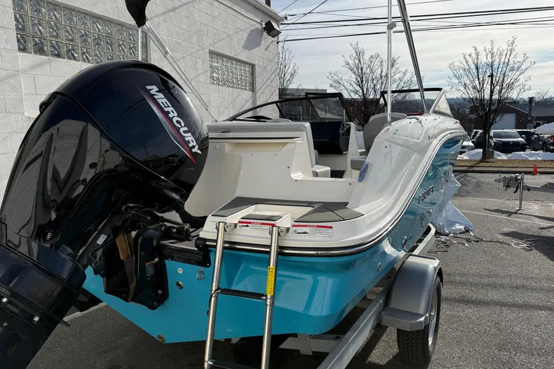 Slide: The Image of 2026 Bayliner V20 boat with Mercury engine on trailer, parked outdoors. - 3