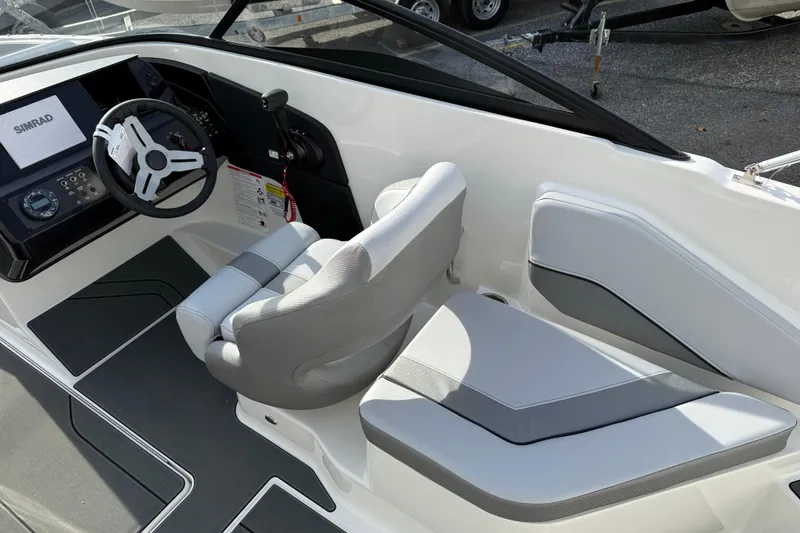 Slide: The Image of Interior of 2026 Bayliner V20 boat with modern steering and seating. - 6