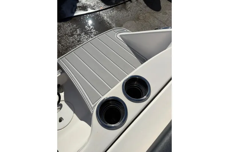 Slide: The Image of 2020 Robalo R227 Dual Console boat deck with cup holders and non-slip surface. - 15