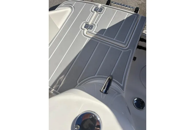 Slide: The Image of 2020 Robalo R227 Dual Console boat deck with sleek design and stainless steel fittings. - 16
