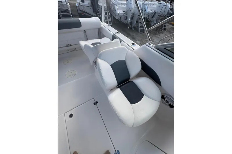 Slide: The Image of 2020 Robalo R227 Dual Console boat interior with white and black seating. - 18