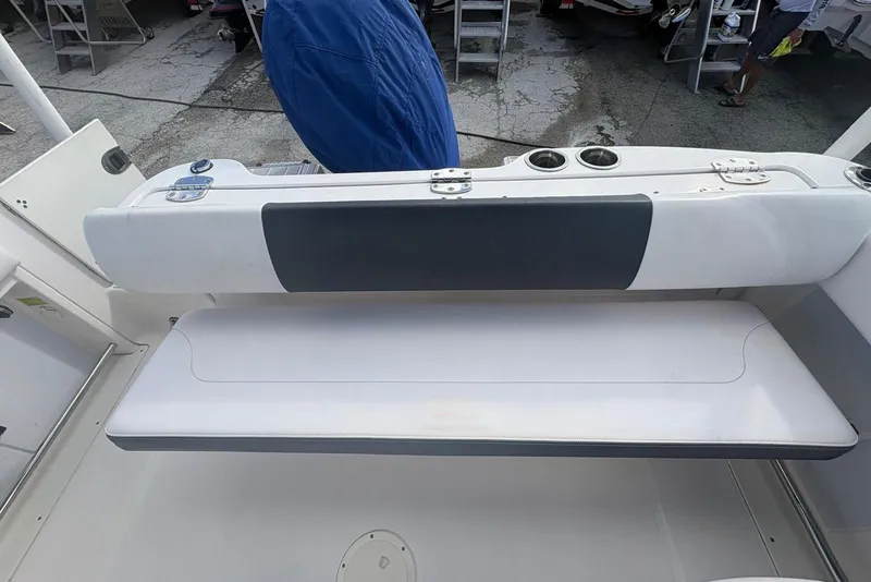 Slide: The Image of 2020 Robalo R227 Dual Console boat seating area with cup holders and storage. - 20
