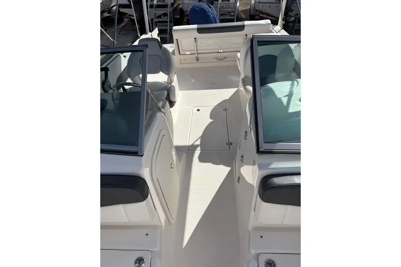 Slide: The Image of 2020 Robalo R227 Dual Console boat interior with seating and windshield. - 21
