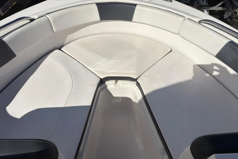 Slide: The Image of 2020 Robalo R227 Dual Console boat interior with white cushioned seating. - 4