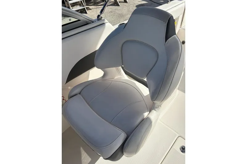 Slide: The Image of 2020 Robalo R227 Dual Console boat seat, featuring sleek gray upholstery. - 9