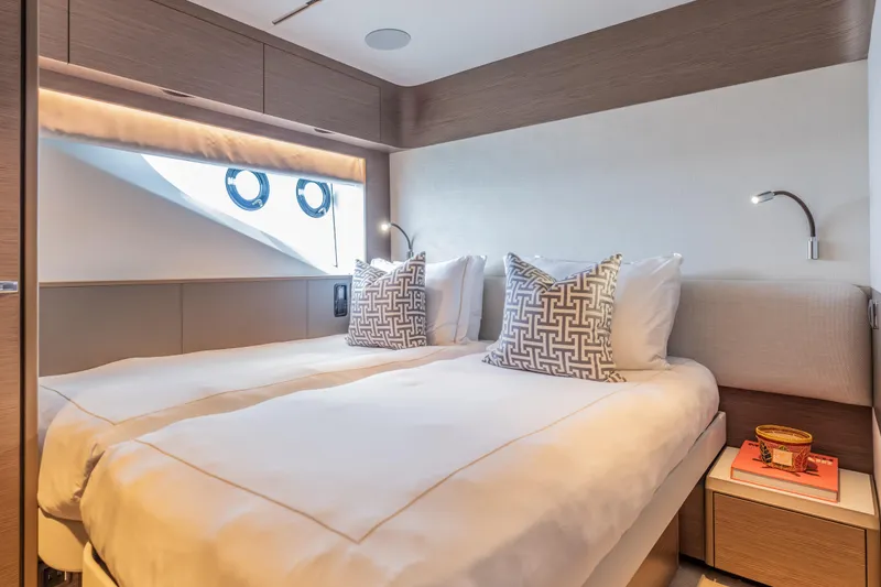 Slide: The Image of Luxurious cabin interior of 2023 Princess X95 yacht with twin beds and modern decor. - 104