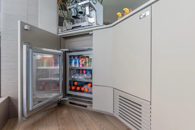 Slide: The Image of Luxury yacht Princess X95 interior with open mini fridge stocked with beverages, 2023 model. - 108