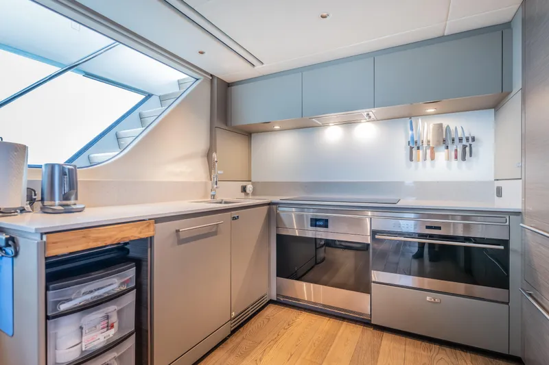 Slide: The Image of Modern kitchen interior on 2023 Princess X95 yacht, featuring sleek appliances and wooden flooring. - 110