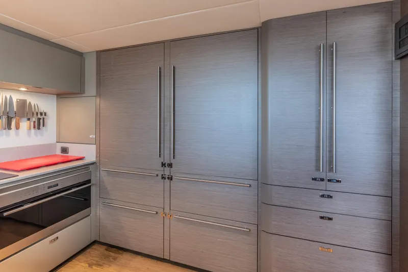 Slide: The Image of Modern kitchen interior on 2023 Princess X95 yacht, featuring sleek cabinetry and built-in appliances. - 111