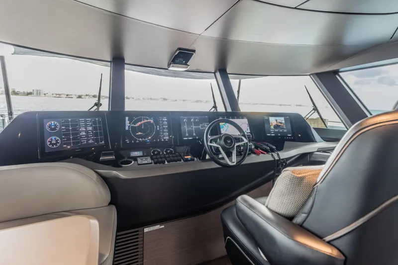 Slide: The Image of Luxurious 2023 Princess X95 yacht cockpit with advanced navigation displays and steering wheel. - 114