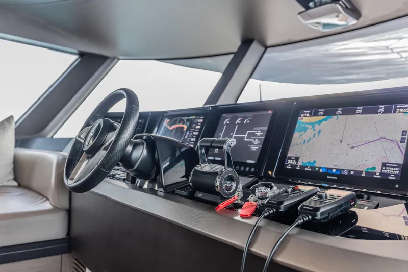 Slide: The Image of 2023 Princess X95 yacht helm with advanced navigation displays and controls. - 115