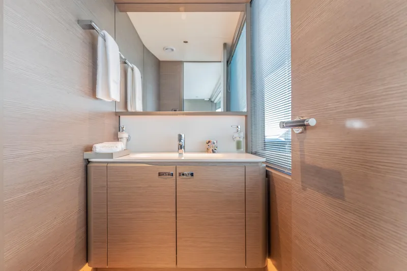Slide: The Image of Luxurious bathroom interior on 2023 Princess X95 yacht, featuring modern sink and wooden cabinetry. - 117
