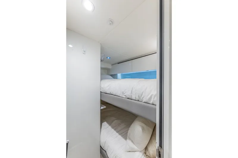 Slide: The Image of 2023 Princess X95 yacht interior with cozy bunk beds and modern lighting. - 120