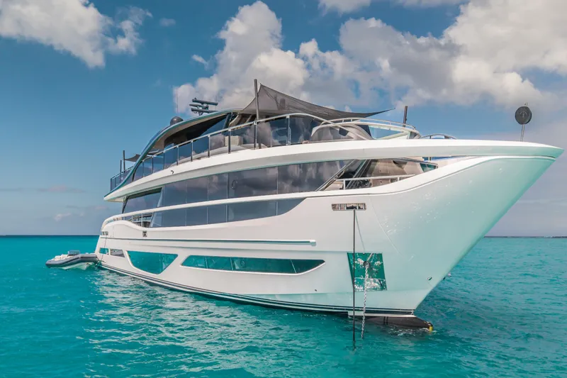 Slide: The Image of Luxurious 2023 Princess X95 yacht on turquoise waters under a partly cloudy sky. - 17