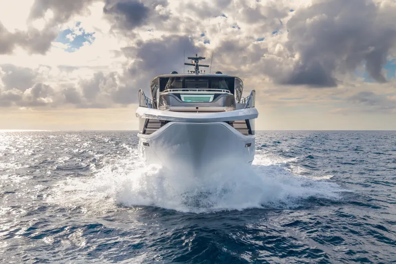 Slide: The Image of 2023 Princess X95 yacht cruising on open sea under cloudy sky. - 2