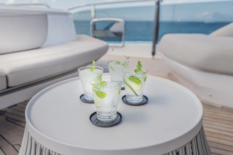 Slide: The Image of Four refreshing cocktails on a table aboard a 2023 Princess X95 yacht. - 53