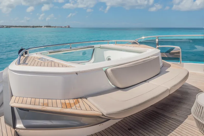Slide: The Image of Luxurious 2023 Princess X95 yacht deck with jacuzzi, overlooking serene ocean waters. - 54