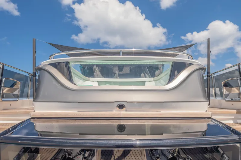 Slide: The Image of 2023 Princess X95 yacht rear view with sleek design under blue sky. - 56