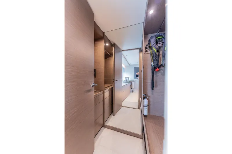 Slide: The Image of Luxurious interior hallway of 2023 Princess X95 yacht with modern wood finishes. - 75