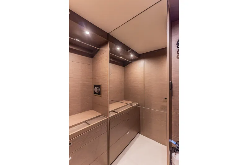 Slide: The Image of Luxurious interior of 2023 Princess X95 yacht with sleek wood paneling and modern lighting. - 76