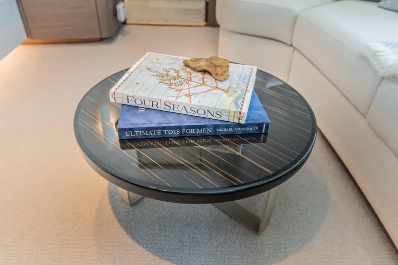 Slide: The Image of Luxurious Princess X95 yacht interior with elegant round table and decorative books, 2023 model. - 79