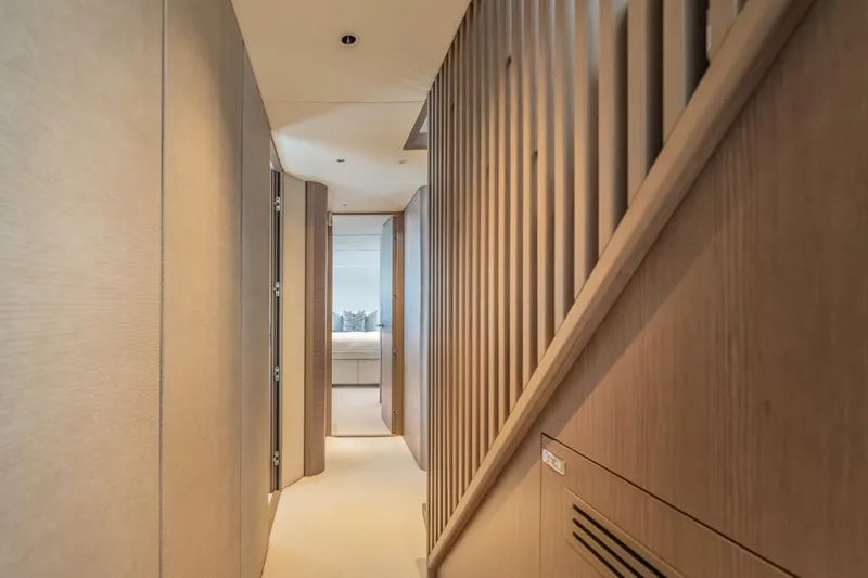 Slide: The Image of Luxurious interior hallway of 2023 Princess X95 yacht, featuring modern wood paneling. - 80