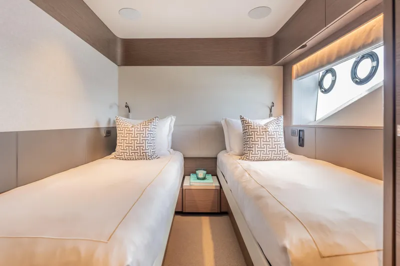 Slide: The Image of Luxurious twin cabin interior on 2023 Princess X95 yacht, featuring elegant bedding and modern design. - 81
