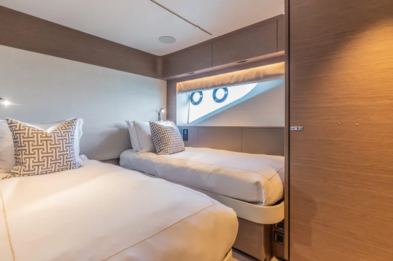 Slide: The Image of Luxurious twin cabin interior on 2023 Princess X95 yacht, featuring elegant bedding and modern design. - 84