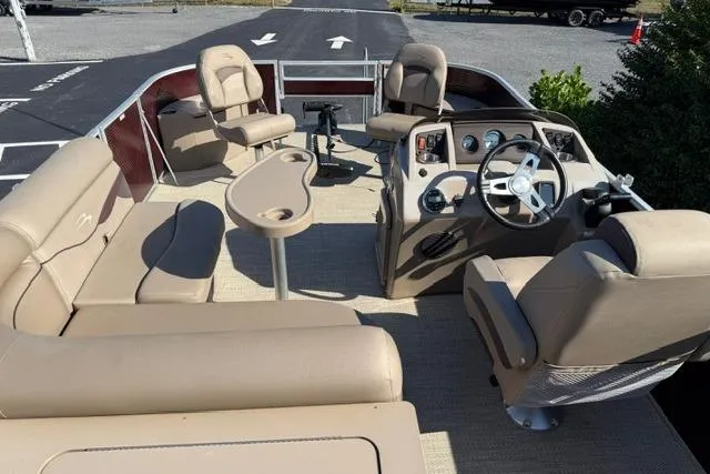 Slide: The Image of 2019 Bennington 20 SFX pontoon boat interior with beige seating and steering console. - 10