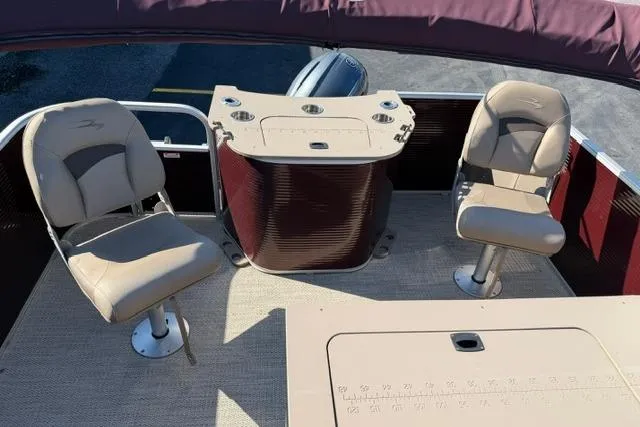 Slide: The Image of 2019 Bennington 20 SFX boat interior with two seats and a control panel. - 11