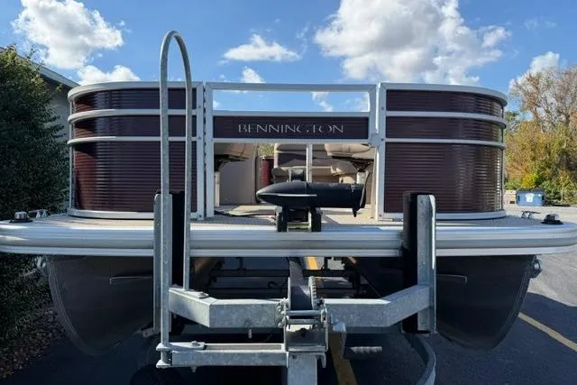 Slide: The Image of 2019 Bennington 20 SFX pontoon boat on trailer under a blue sky. - 3