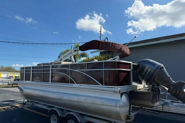 Slide: The Image of 2019 Bennington 20 SFX pontoon boat on trailer under blue sky. - 5