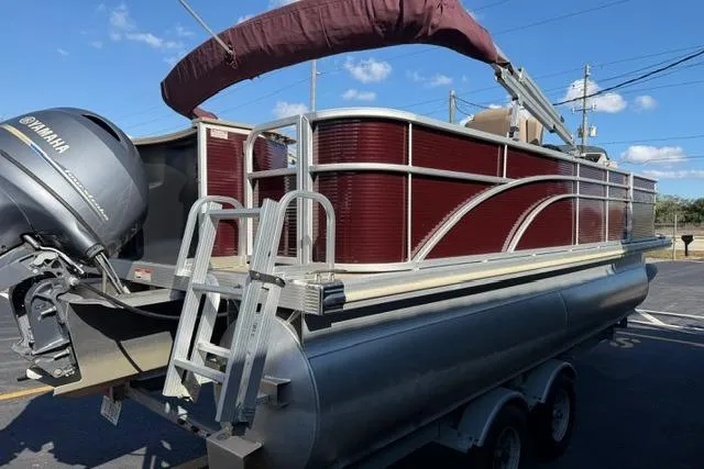 Slide: The Image of 2019 Bennington 20 SFX pontoon boat with Yamaha motor, parked on a trailer. - 8