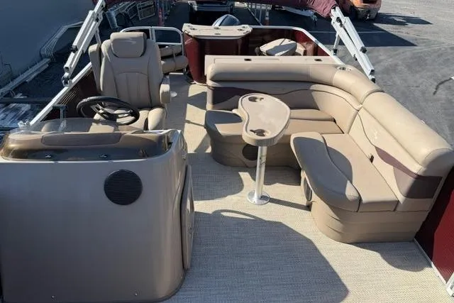 Slide: The Image of 2019 Bennington 20 SFX pontoon boat interior with beige seating and steering console. - 9
