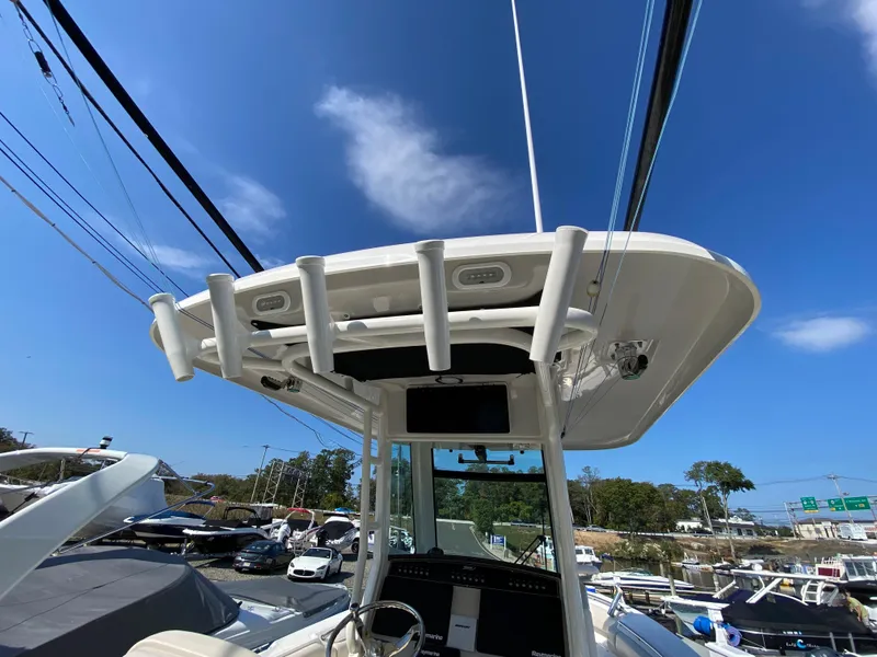 Slide: The Image of Boston Whaler 250 Outrage 2020 with T-top and fishing rod holders. - 12
