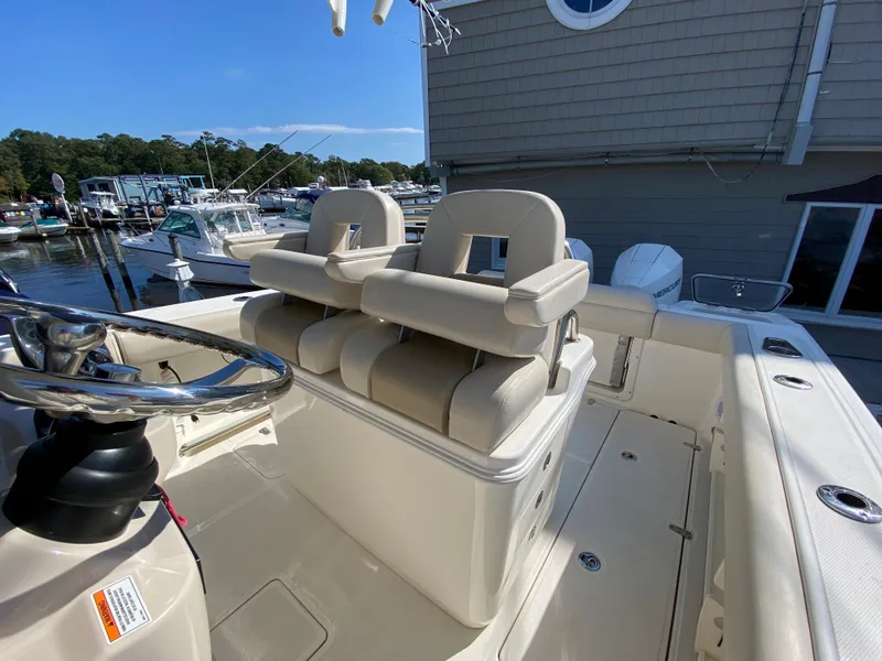 Slide: The Image of 2020 Boston Whaler 250 Outrage with comfortable seating at the marina. - 21