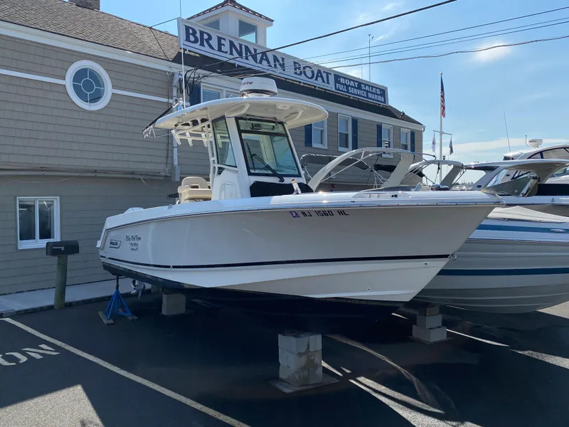 Slide: The Image of 2020 Boston Whaler 250 Outrage displayed outside a boat building. - 7
