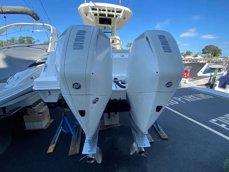 Slide: The Image of 2020 Boston Whaler 250 Outrage with twin outboard engines at the dock. - 8