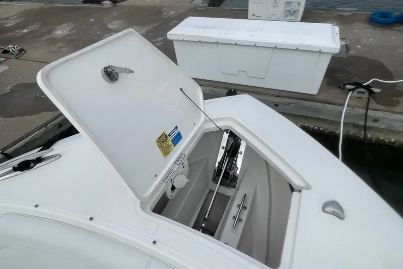 Slide: The Image of 2021 Pursuit S 328 Sport boat with open storage compartment at dock. - 12