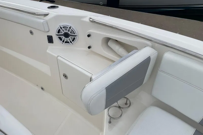 Slide: The Image of 2021 Pursuit S 328 Sport boat interior with speaker and seating area. - 14