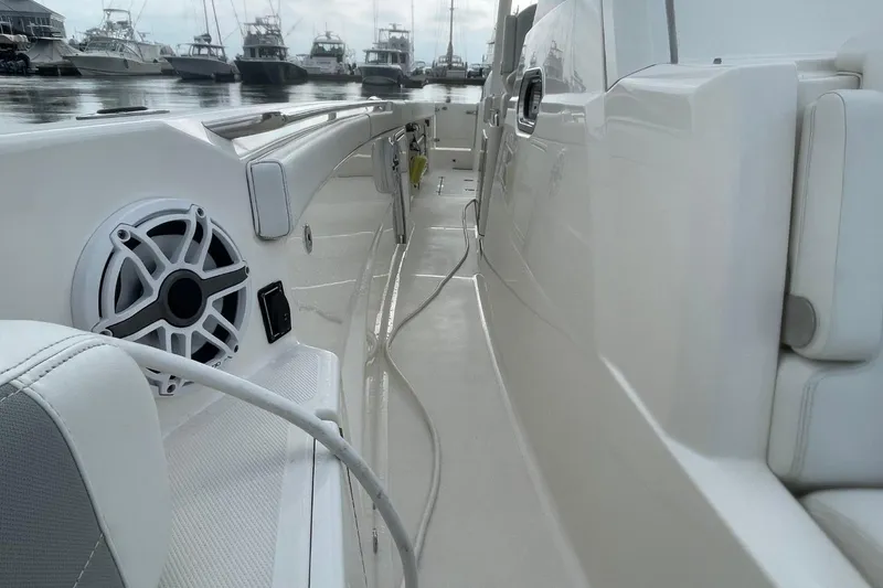Slide: The Image of 2021 Pursuit S 328 Sport boat interior with speaker, docked at marina. - 15