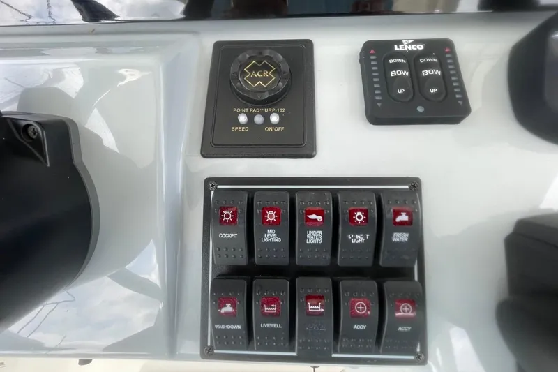 Slide: The Image of Control panel of 2021 Pursuit S 328 Sport boat with various switches and buttons. - 22