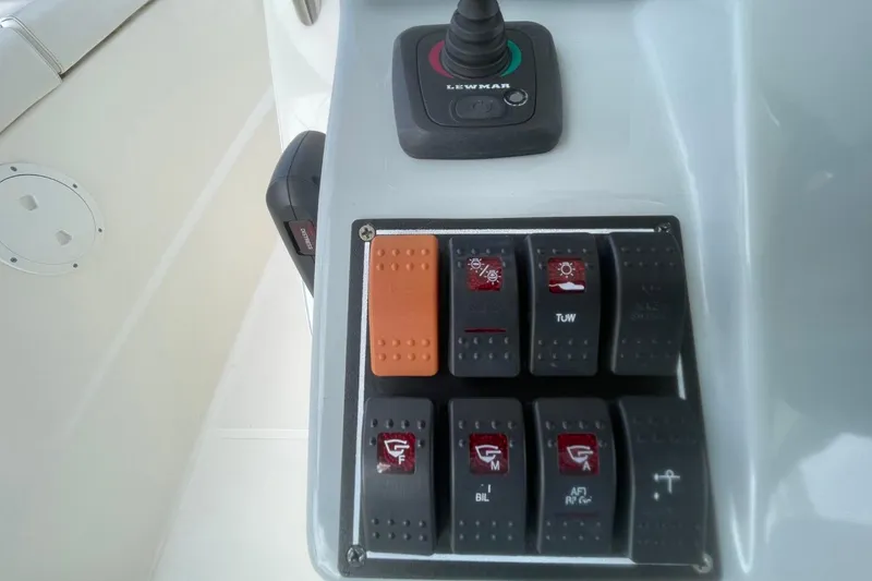 Slide: The Image of Control panel of 2021 Pursuit S 328 Sport boat with switches and joystick. - 23