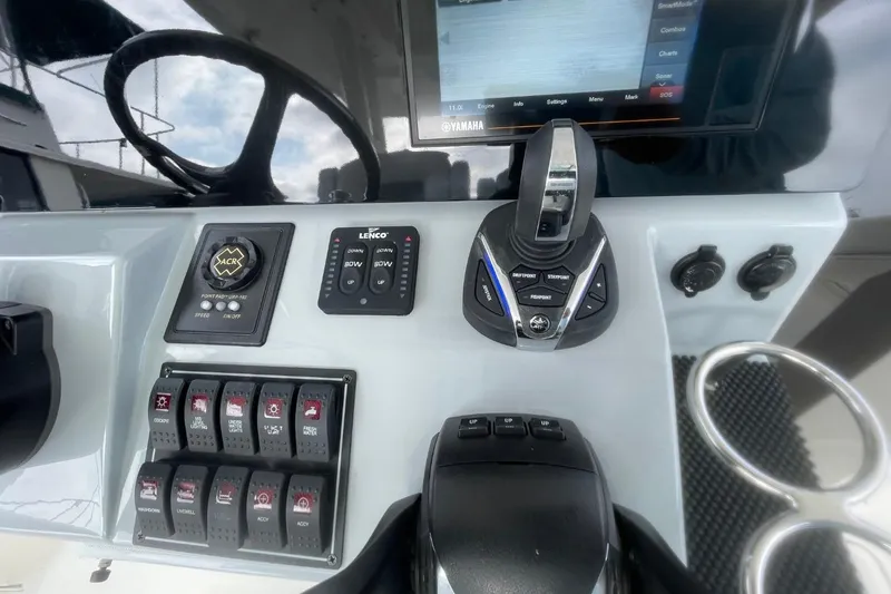 Slide: The Image of 2021 Pursuit S 328 Sport boat dashboard with controls and display screen. - 24