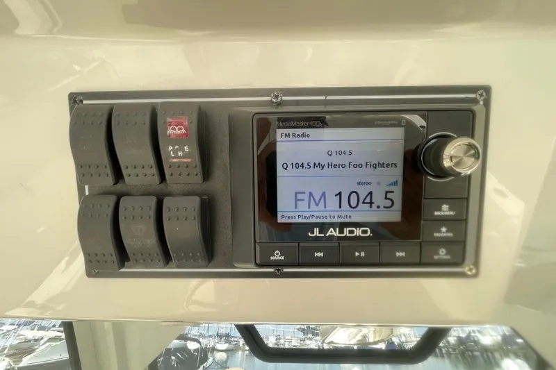 Slide: The Image of 2021 Pursuit S 328 Sport boat audio system displaying FM radio station 104.5. - 26