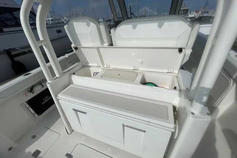 Slide: The Image of 2021 Pursuit S 328 Sport boat interior with open storage compartments. - 33